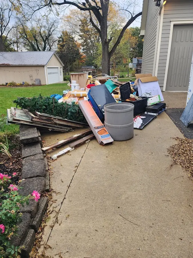 Dumpster being loaded with debris for 12 Yard Dumpster Rental in Bridgeton